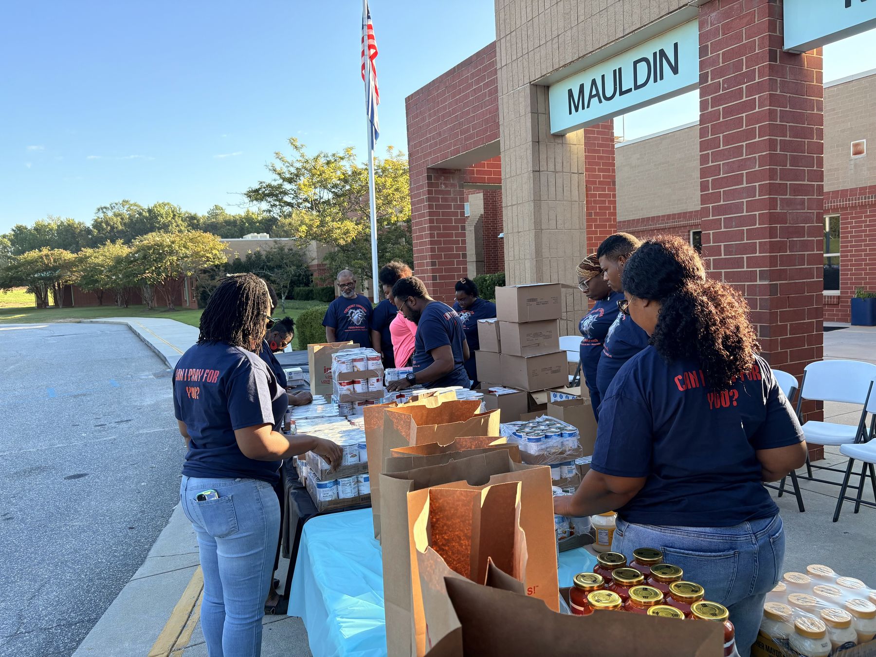 Volunteers handing out food at an outreach distribution