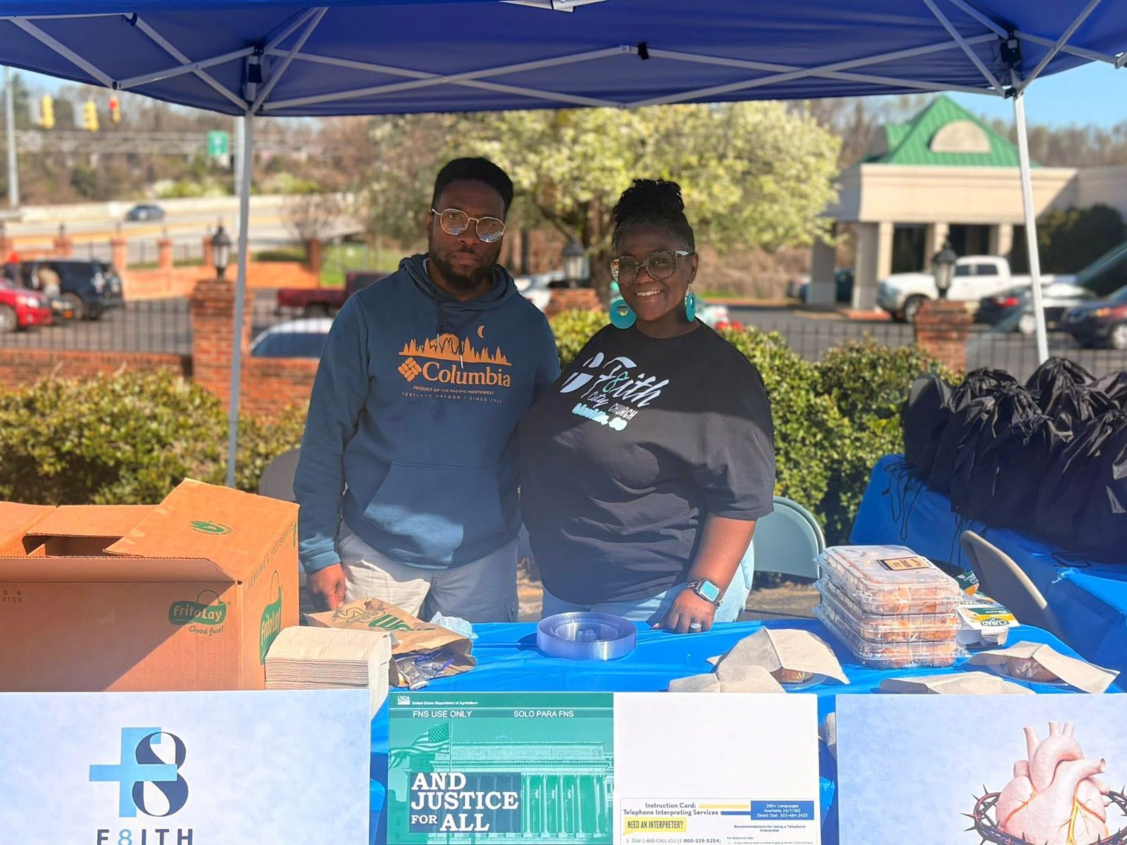 Two volunteers at the F8ith outreach table